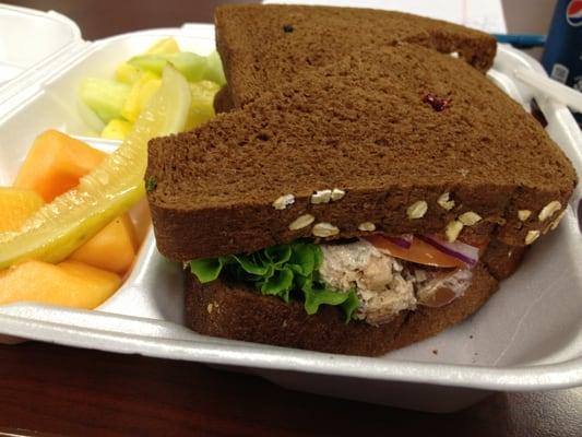 Chicken salad sandwich with side of fruit