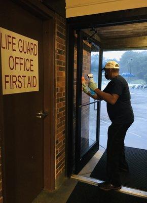 Cleaning glass door at a pool