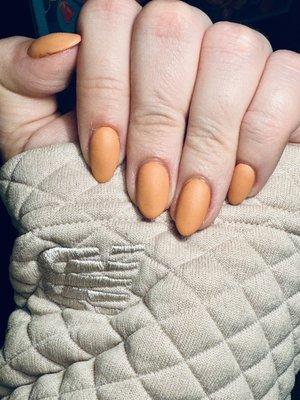 Orange colored manicured nails