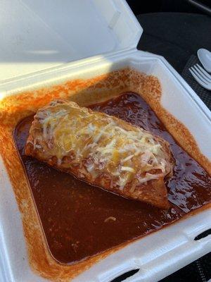 Carne asada burrito served wet with mild red homemade enchilada sauce