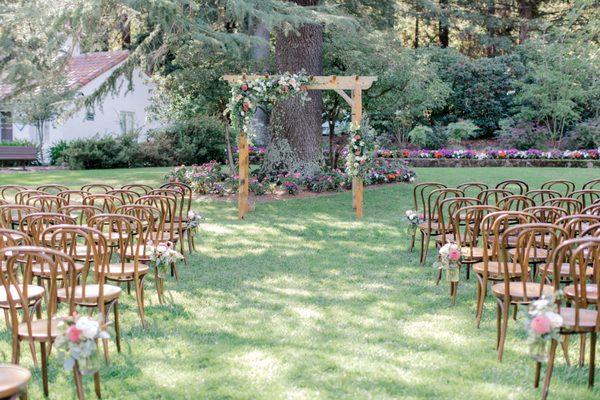 An outdoor ceremony set up awaiting guests to arrive.