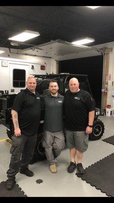 Chris Hansen and Chris Jaglinski (in black polo shirts) with a past student.