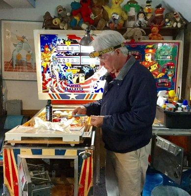 Cliff is cleaning, replacing and tuning up a 1975 pinball machine called, "Spirit of '76"