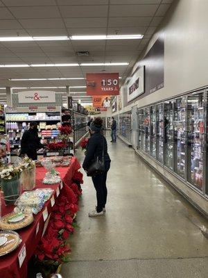 Manager shooting the breeze while  A line of ten customers wait