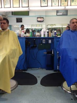 4 chairs, about 12 chairs for waiting. Usually 3 barbers working. Loud Spanish only news or soccer