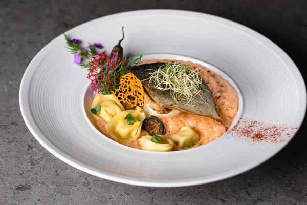 Branzino, Panang curry, tortellini, eggplant, alfalfa sprouts, roasted brussels sprouts, edible flowers, veggies, coral tuile for garnish