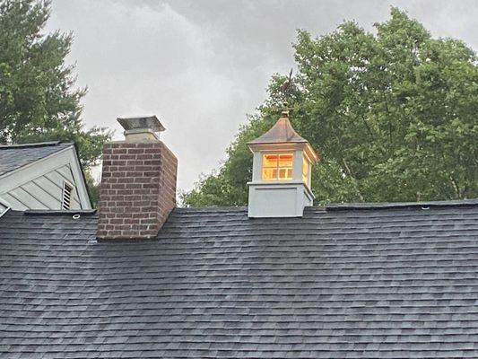 brick chase and cupola installed on garage roof.