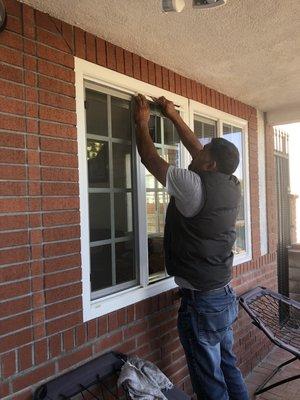 Employee replacing front windows