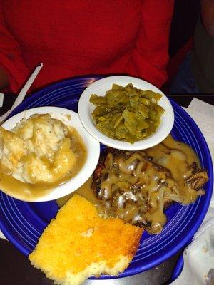 Hamburger steak onions and gravy, mashed potatoes and green beans