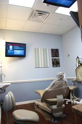 Treatment room with TVs on the ceiling and wall for your enjoyment