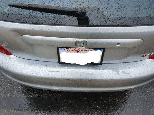 Before (dent left of trunk handle and scratched peeling paint on bumper)