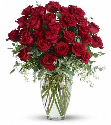 Roses, roses and more roses are arranged with beautiful eucalyptus and a lovely ming vase.