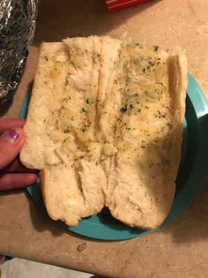 Nasty ass Cold garlic bread that has barely any spread and not even toasted