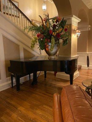 Gorgeous flowers on grand piano in entry