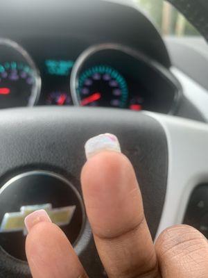 Nail tech didn't clean the old nail polish from underneath the nail.