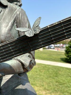 Note the butterfly on her guitar