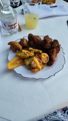 Appetizer plate: BBQ Chicken wings, salt fish fritters, plantain, sauteed shrimp