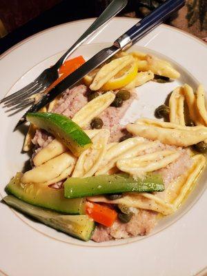 Veal piccata dinner with pasta, fresh zucchini, carrots.