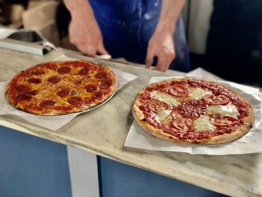 Wood-fired pizzas fresh out of the oven.