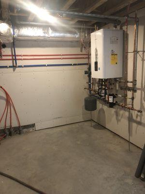 New installation of NAVIEN High EFF combo unit with new domestic water piping and heating lines.