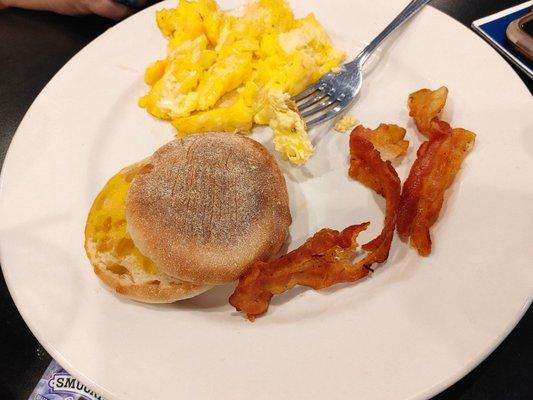 Basic breakfast with English muffin bacon and scrambled eggs