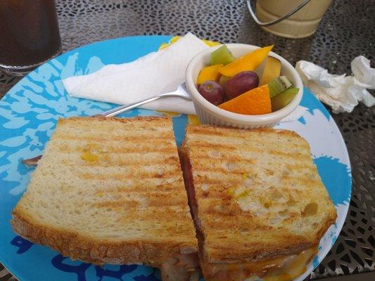 Ham and cheese panini with a side of fruit