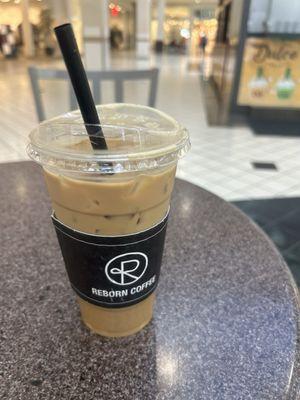 Iced vanilla latte with oat milk