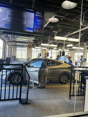 Getting the Works! After the car wash they are now cleaning the interior of my car.