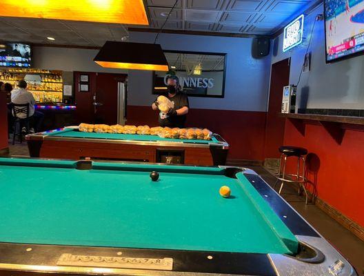 Surely there's a better place to put the bread than on the never-been-cleaned pool tables?