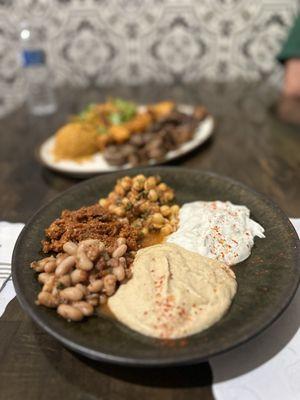 Appetizer plate with hummus, chickpeas, beans, yogurt sauce and pepper paste sauce