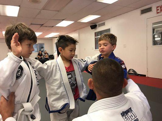 Coach Gary telling our little warriors to never do Jiu Jitsu at home or school unless they are in danger.