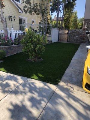 Artificial grass and border wall installed by Thunder Masonry.