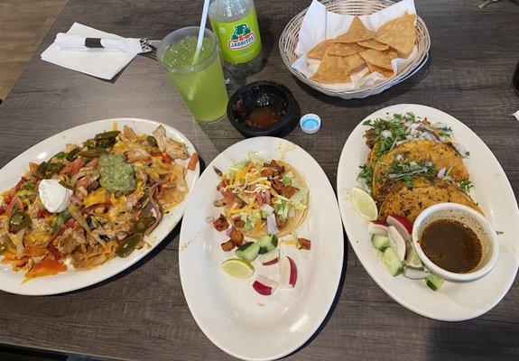 Fajita Nachos with chicken. Al pastor taco. Birria tacos.