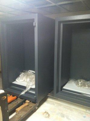 Two 8000 lbs safe being installed without doors to reduce weight load on floor.