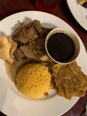 Beef vieja with yellow rice, black beans and tostones.