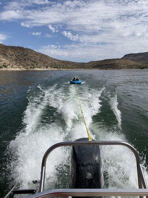 Kids on the water behind the pontoon boat Looney Tune