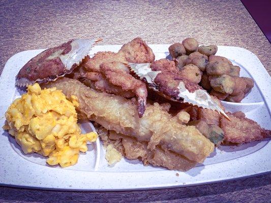 Deluxe Seafood Platter with sides of Mac 'n Cheese and fried okra. Crab cakes, shrimp, 2 fish fillets and hush puppies.