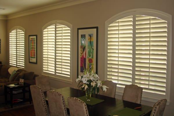 Beautiful arched plantation shutters. The extra wide louvers are the appropriate scale for these windows.