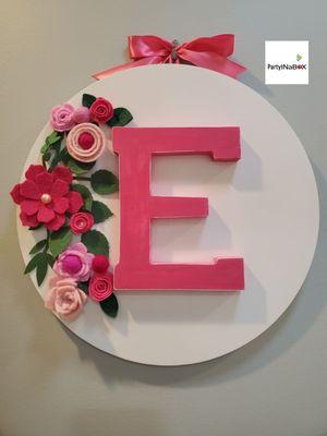 A hand made round wood wall decorations with the initial letter  for a girl room.