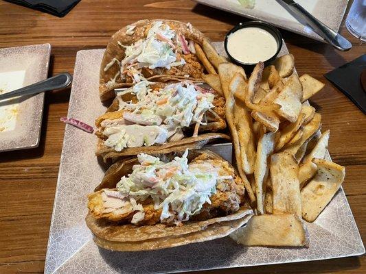 Taco with fried chicken and fries.