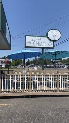 Sign and some outdoor seating out front