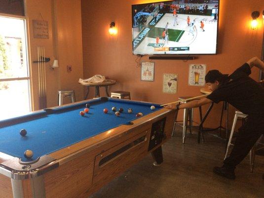 Pool table game in play and sports on our tv