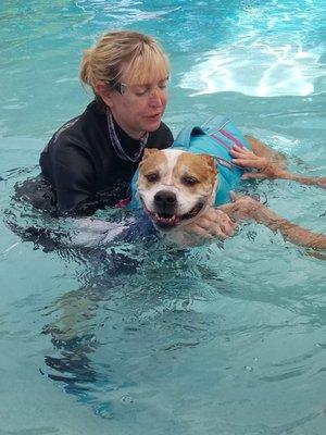 Making sure he maintains form while swimming