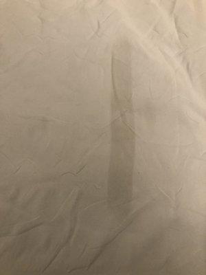 Burn mark left on my white comforter after bringing to the dry cleaner