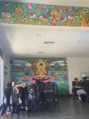 A section of the restaurant with beautiful Salvadoran murals