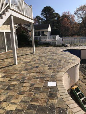 Pool deck paver installation.