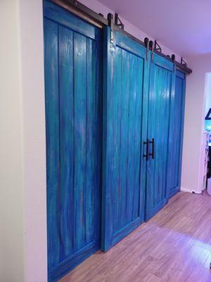 Custom aqua blue / black shaded barn doors 2" x 1/4" steel straps double railed these doors are custom retrofitted.