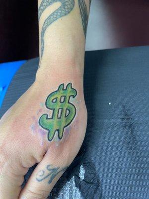 small Color Hand Tattoo Of. Dollar Sign