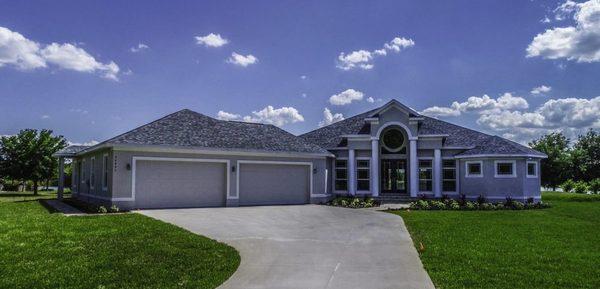 This one story custom designed home built by Rotunda Homes features a courtyard style garage.