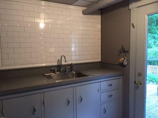 Open up a below-grade utility space with a crackle glaze subway wall. Not dreary anymore!